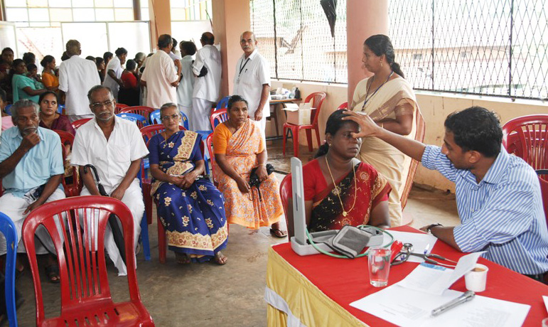 A doctor examines a patient at a free health camp